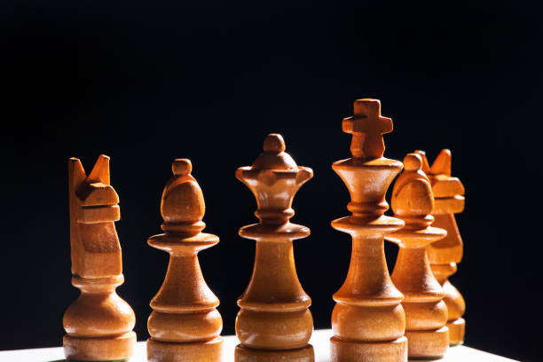 istock Chess pieces,beautiful old chess pieces on a board, black background, selective focus. 1957407786