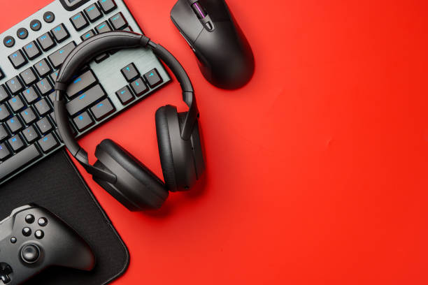 istock Computer keyboard and headphones on red background top view 1957408325