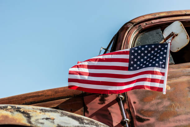 istock old rusty truck with USA flag 1957408919