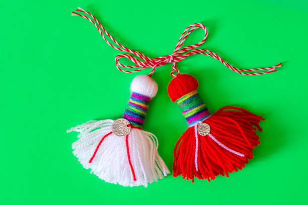 Bulgarian symbol of spring white and red martenitsa on green background