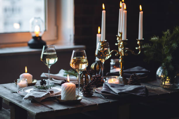 istock Rustic elegant table decor for christmas family dinner. Center piece with white candle, pine cone, fir tree branches. Zero waste eco-friendly home decoration. Cozy atmosphere, wooden background. 1957426822