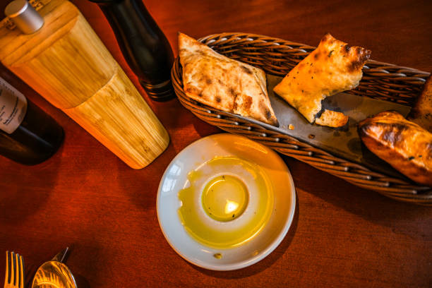 istock Pastry, olive oil on small plate, spice rack, cutlery on restaurant table. 1957453184