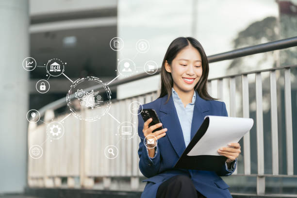 istock Women hand working with laptop computer, tablet and smart phone in modern office with virtual icon diagram in city Outside Office. 1957456908