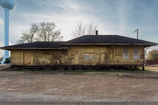 istock Boarded up train depot left abandoned with vines growing on walls 1957461220