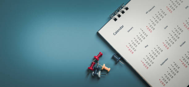 istock Embroidered red pins on a calendar event Planner calendar,clock to set timetable organize schedule,planning for business meeting or travel planning concept. 1957481754