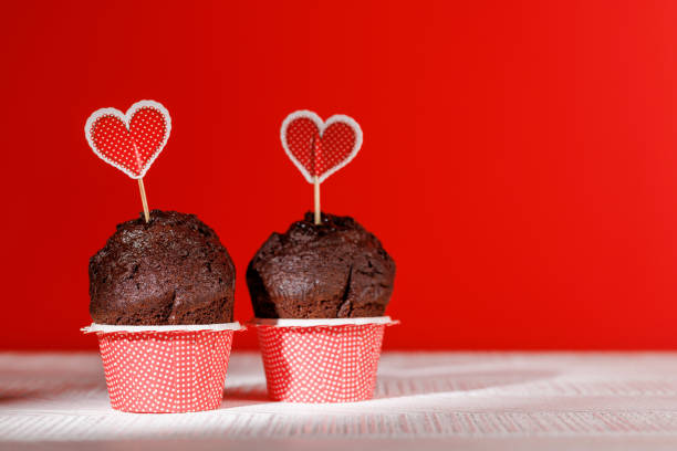 istock Cupcake love: Heart-themed treats on a vibrant red backdrop 1957482302