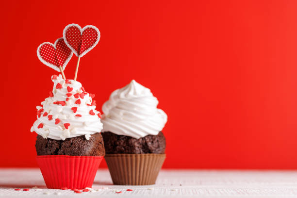 istock Cupcake love: Heart-themed treats on a vibrant red backdrop 1957483904