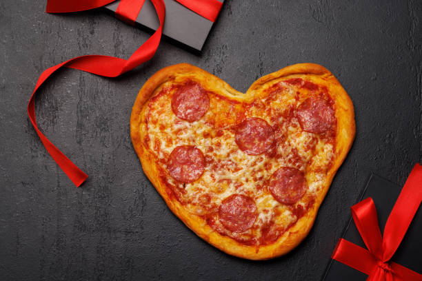 istock Heart-shaped pizza: Delicious love-themed dish 1957491935