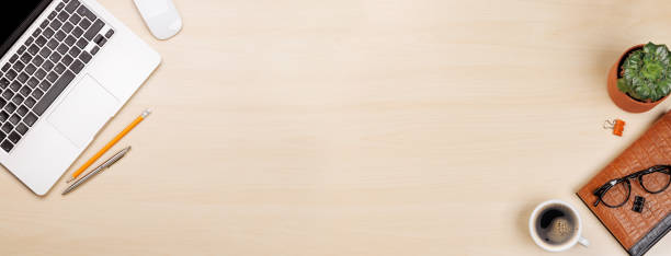 istock Workplace essentials: Laptop, coffee, notepad, supplies 1957500420