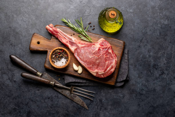 Raw Tomahawk beef steak and spices