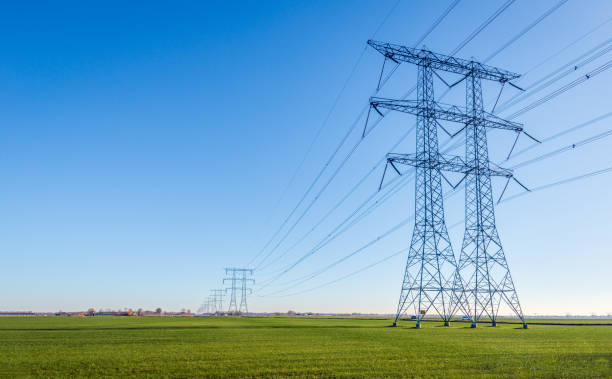 istock High-voltage pylons and lines contrasting against a blue sky 1957515196