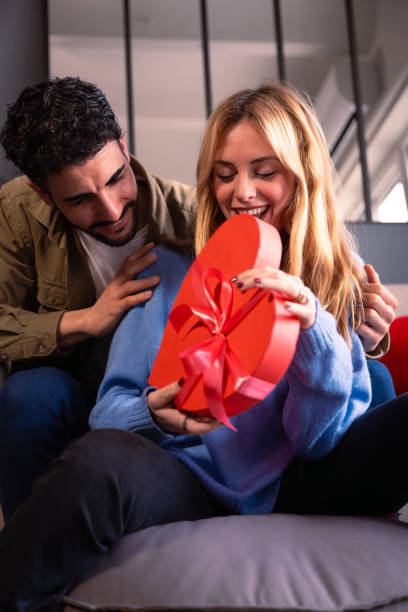 istock Loving young couple with heart-shaped gift box. Valentine's Day Celebration. vertical 1957518970