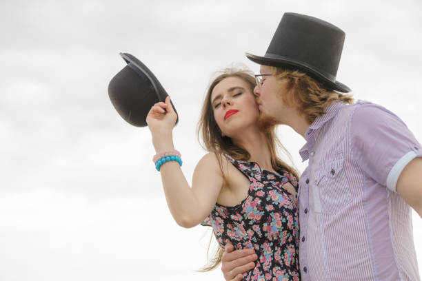 Handsome man piggy backing his wife against white background