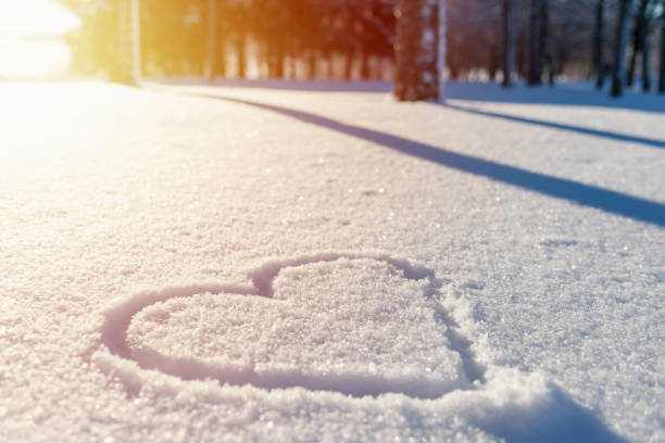 istock Nice heart shape on the fresh snow winter sunset lanscape,park or forest. 1957570039