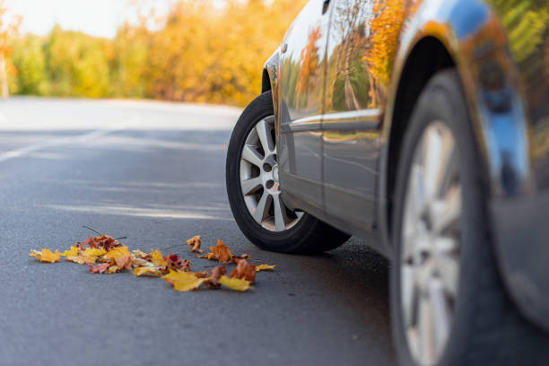 istock Car on asphalt road on autumn day at forest or park.Selective focus,copy space. 1957596067