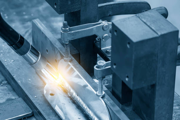 istock Close up scene the welding process by robotic system in the light blue scene with lighting effect. 1957611770
