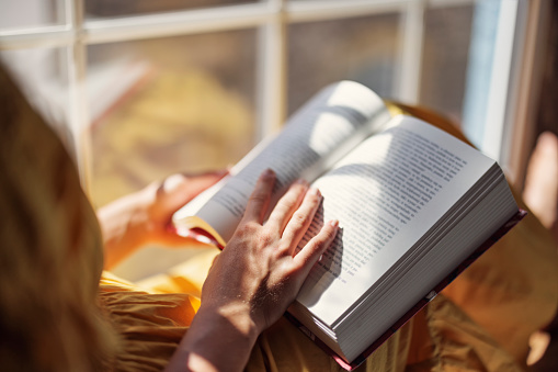 Teenage girl enjoying reading a book on windowsill. Sunny summer day.
Shot with Canon R5