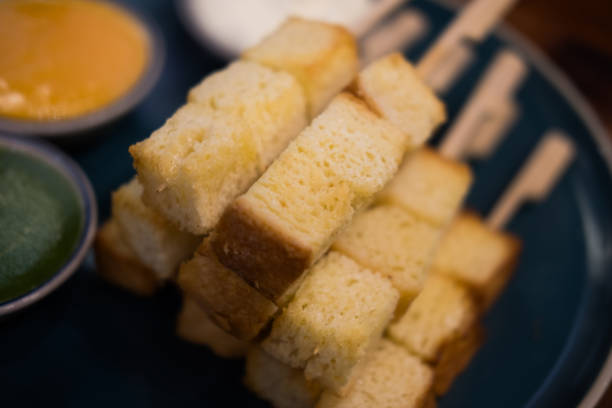 istock Slightly golden toast cut square, just the right size put in a stick 1957620292