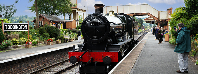 January 24th. 2024 A Heritage steam locomotive at Toddington Station on the Gloucestershire and Warwickshire railway, The Cotswolds, England UK. This is a popular tourist railway on a sunny summers day. There are visitors on the platform.