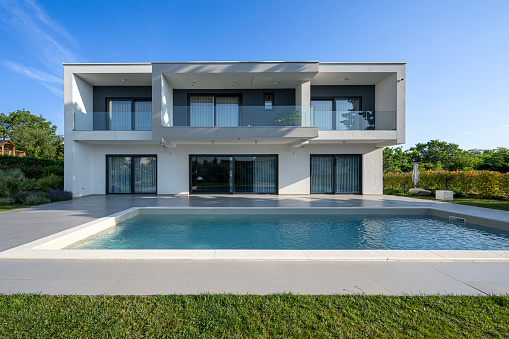 Exterior view of modern luxury house with swimming pool.