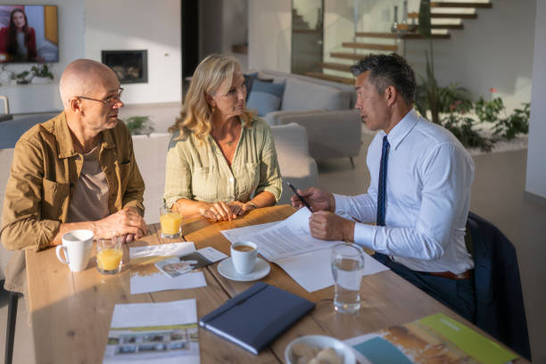 istock Male estate agent talking with couple 1957644920