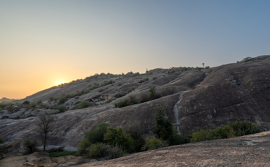 Vibrant sunset over the dramatic boulder covered landscape in the Jawai region of Rajasthan, India Asia.