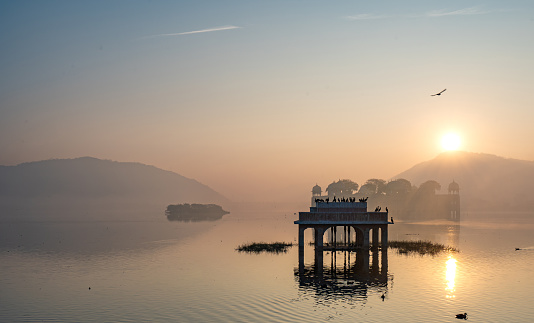 Beautiful Jal Mahal water palace during a vibrant winter sunrise in Jaipur, Rajasthan, India Asia