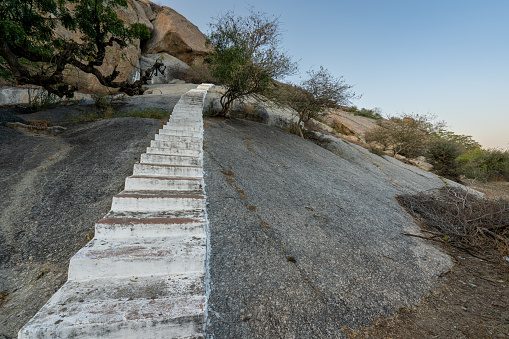 Entrance to the Perwa Hill Shiva Temple in the dramatic boulder covered landscape in the Jawai Region of Rajasthan, India Asia.