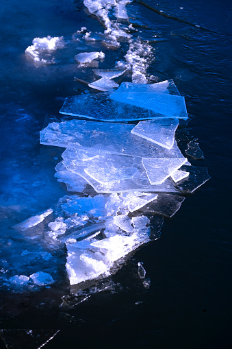 Ice crystals and forms on frozen river water in wilderness patters of nature