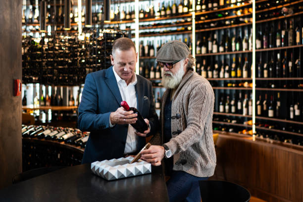 istock Two friends choosing wine in a wine bar 1957735619