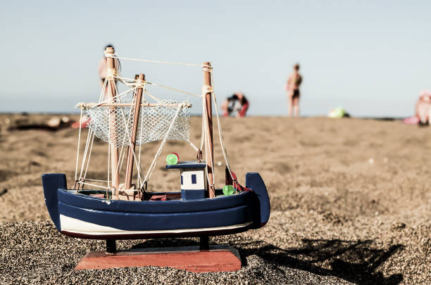 Photo Picture of a Toy Boat on the Sand Beach