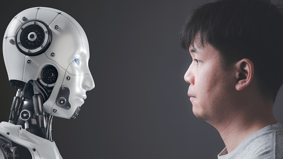 The faces of human and a robot on opposite sides Looking at each other, Modern AI technology concept, humans and robots, competition between human intelligence and artificial intelligence.