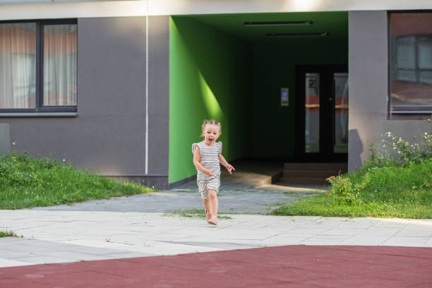 istock Joyful Toddler Running on a Pathway Outdoors. 1957754134