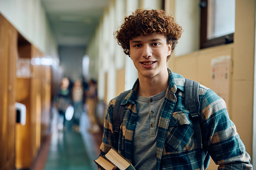 Smiling male student in high school looking at camera. Copy space.