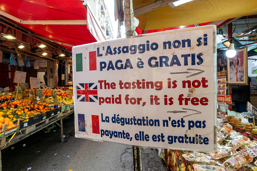 Palermo, Sicily, Italy Jan 12, 2024 A sign in the Mercato di Ballaro street market in Italian French and English says: The tasting is not paid for, it is free.\