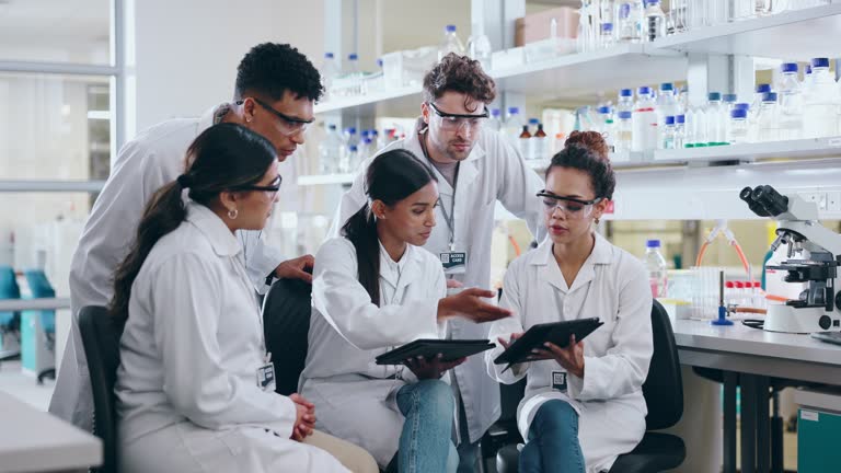 People, scientist and tablet in meeting, planning or research for project or discovery in science laboratory. Group of medical health students in team plan, scientific learning and technology at lab