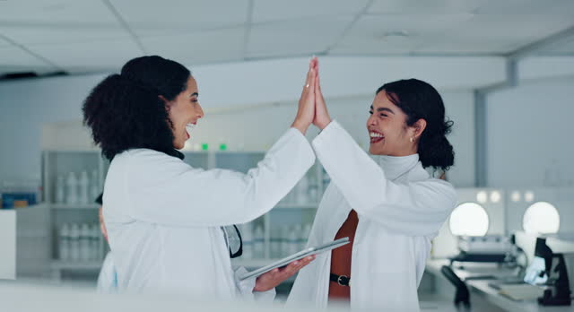 Scientist, teamwork and high five on tablet for research success, medical achievement and test results or goals. Science mentor, student or women in laboratory with wow, well done and hands together