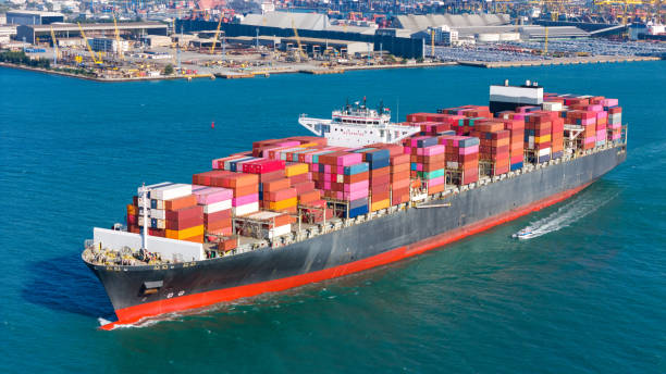 istock Top view Logistics and transportation of Container Cargo ship and Cargo plane with working crane bridge in shipyard at sunrise, logistic import export and transport industry background 1957824511