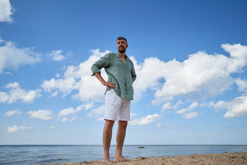 A 35 years old Caucasian male standing against the Baltic sea. Latvia