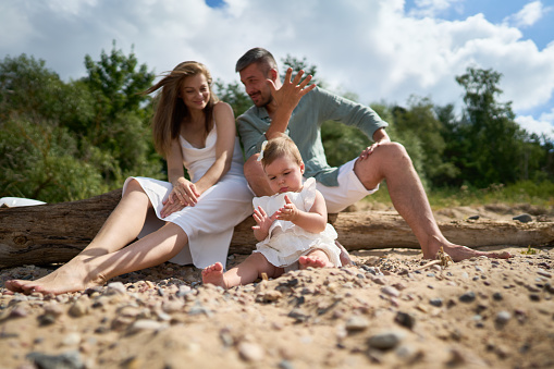 A happy family having fun on summer vacation. Baltic sea, Latvia