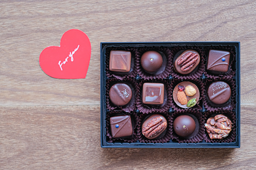 Golden chocolates box on red satin background. on horizontal composition.