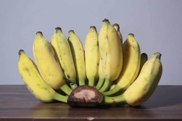 istock Banana fruit with wooden on blurred background 1957847686