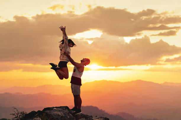 istock Young couple is having fun at mountain top and sunset 1957852415