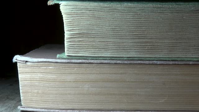 Old books lie on the table, close-up