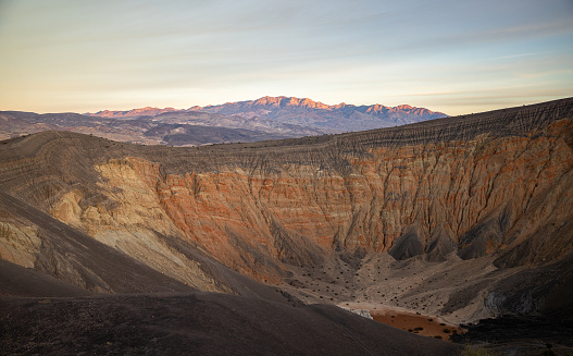 View inside the Ubehebe crater in the Death Valley National Park. Marvel at the vibrant colors adorning the crater walls and geological formations, creating a mesmerizing nature's artistry