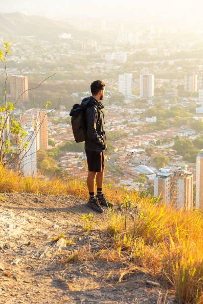 istock young guy with backpack hiking on mountain trail 1957872160
