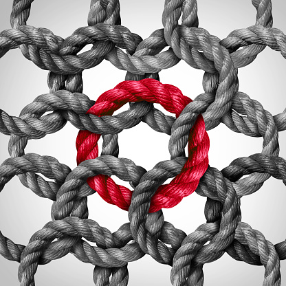 Central link concept and networking or key network connection as a business metaphor with a group of circle ropes connected to one red rope loop as a symbol for connectivity and linking to a centralized support structure and team leader or company leadership.