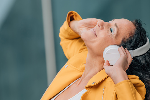 woman with headphones listening relaxed