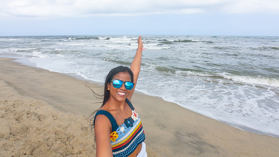 Woman in sunglasses at sunny beach