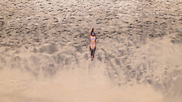 istock Latin Woman Relaxing on Sandy Beach 1957893512